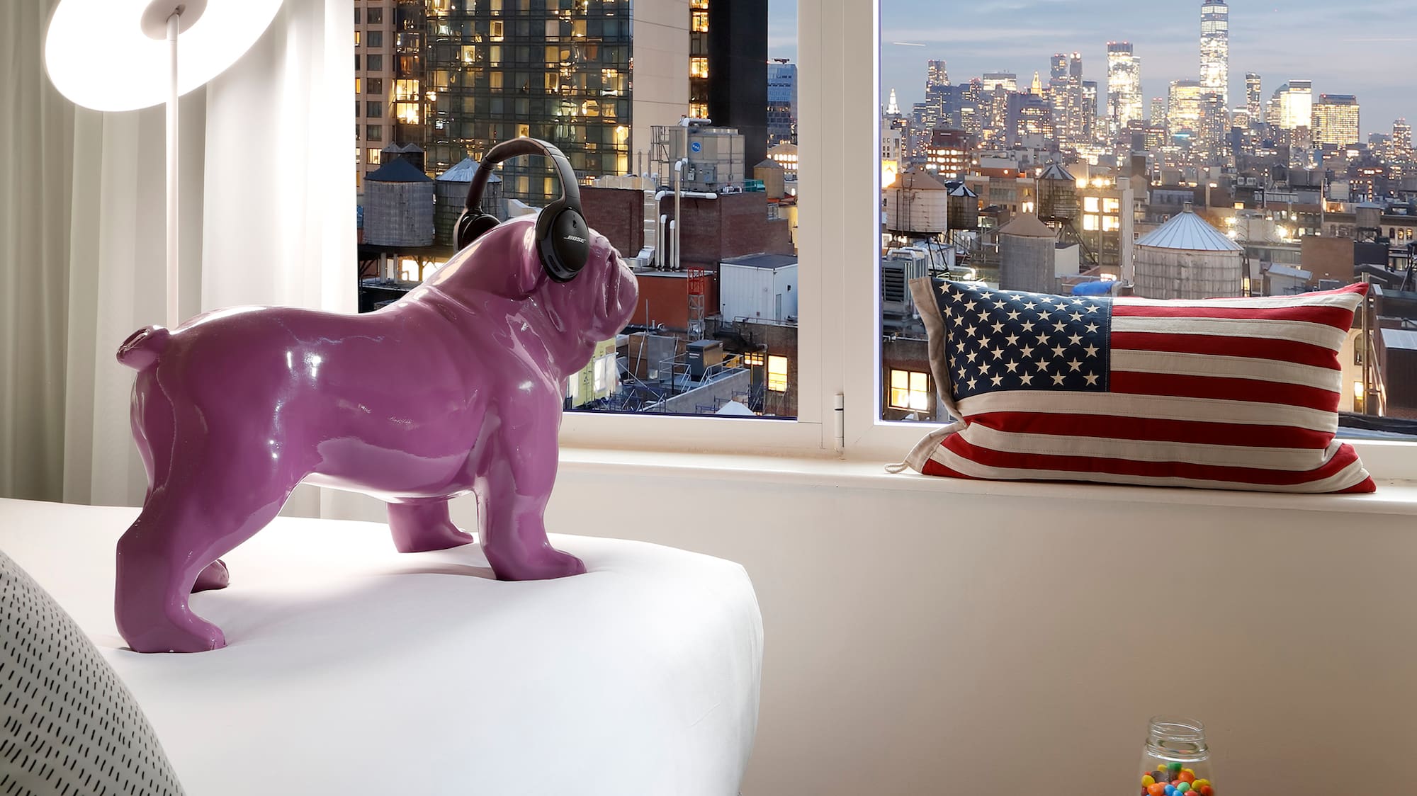 a purple dog statue on a bed