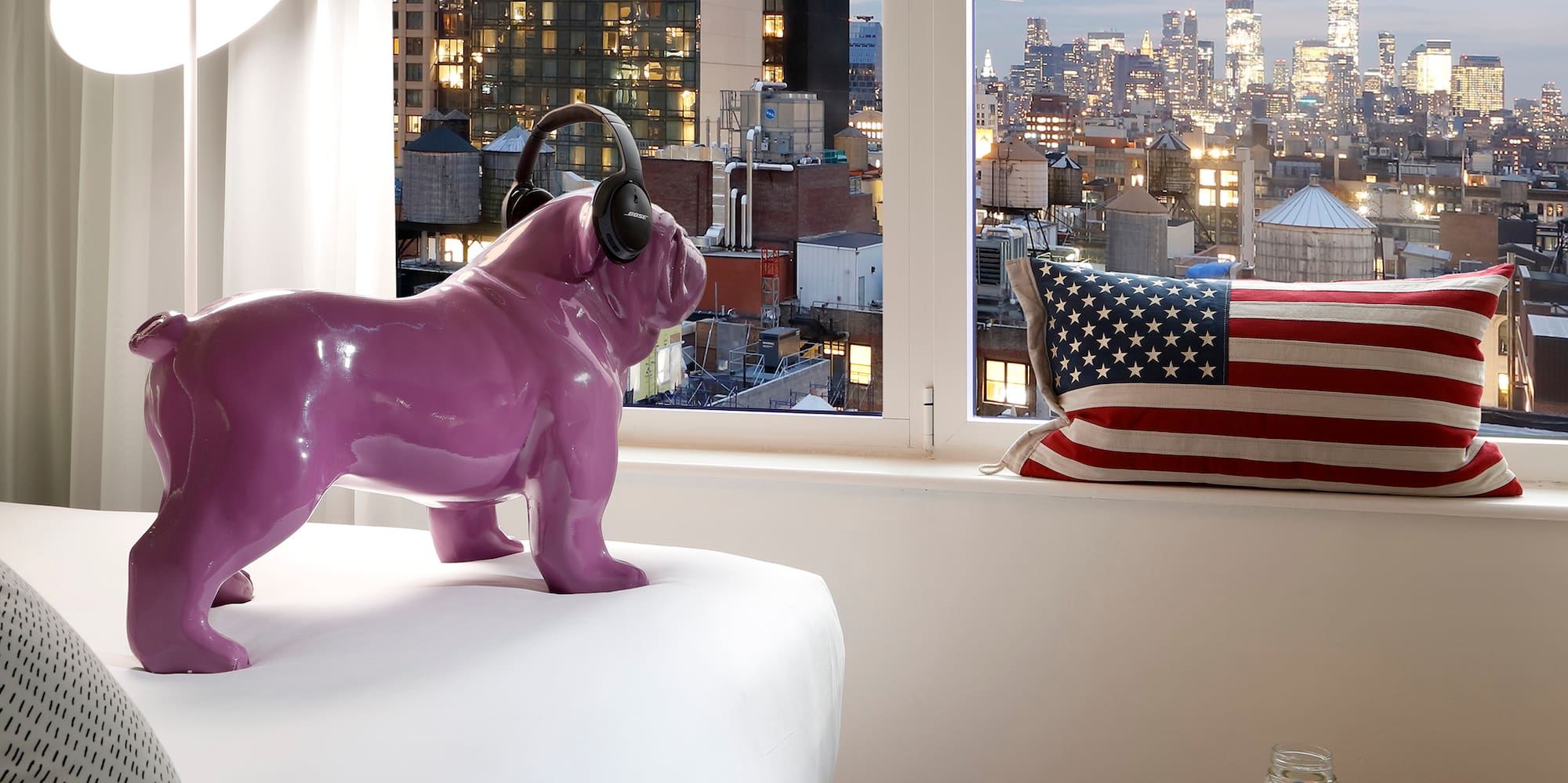 a purple dog statue on a bed