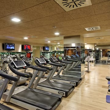 a large room with treadmills and mirrors