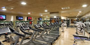 a large room with treadmills and mirrors