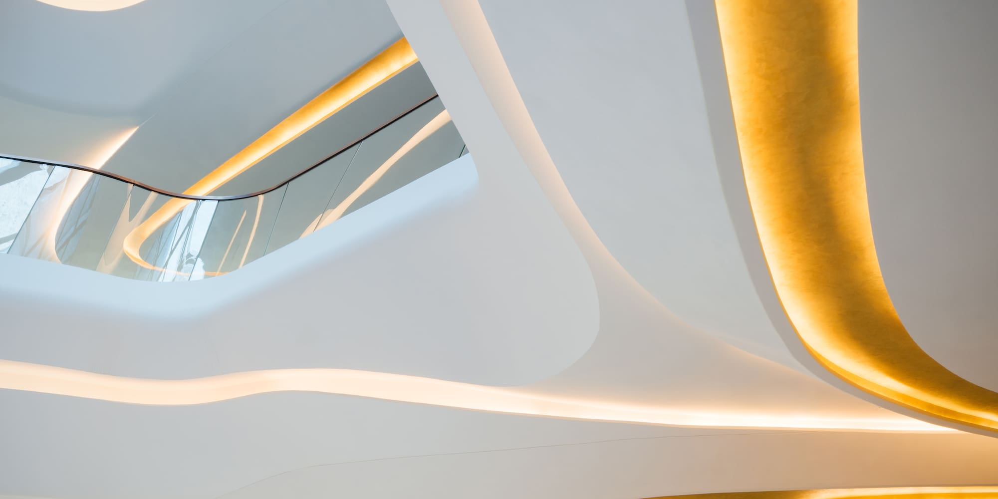 a white and gold ceiling with a staircase