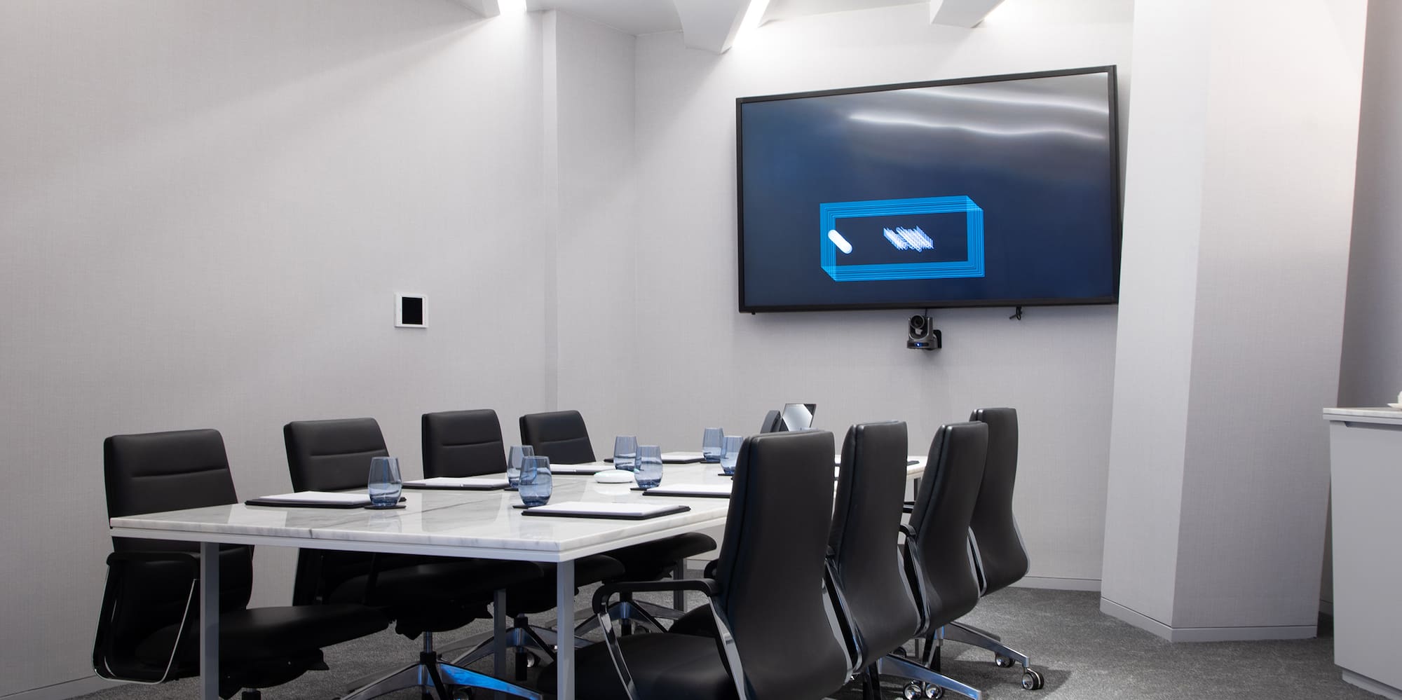 a conference room with a table and chairs