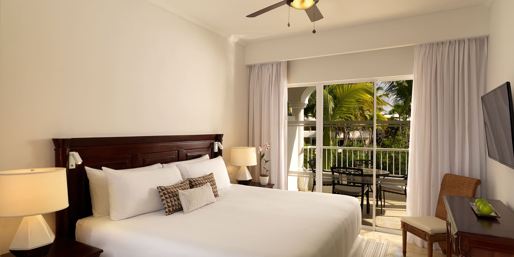 a bedroom with a ceiling fan and a bed