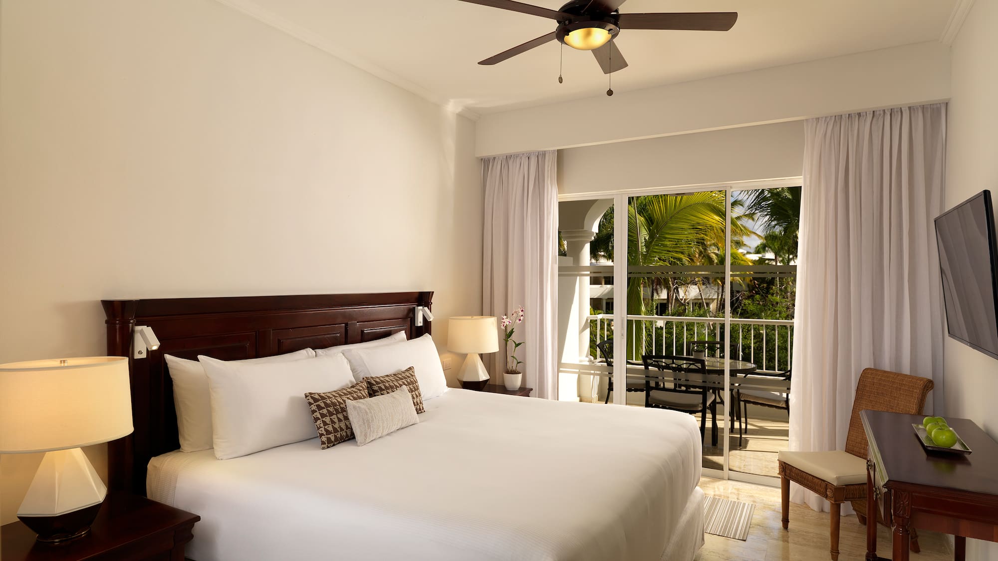 a bedroom with a ceiling fan and a bed