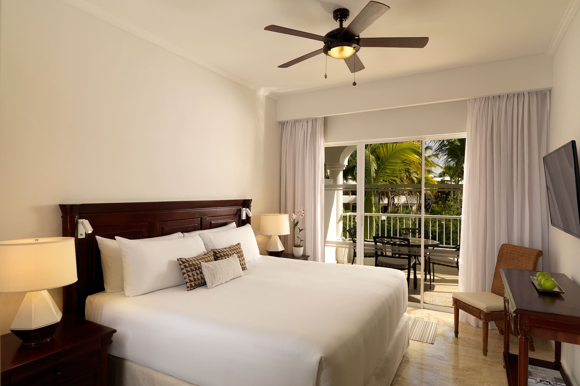 a bedroom with a ceiling fan and a bed