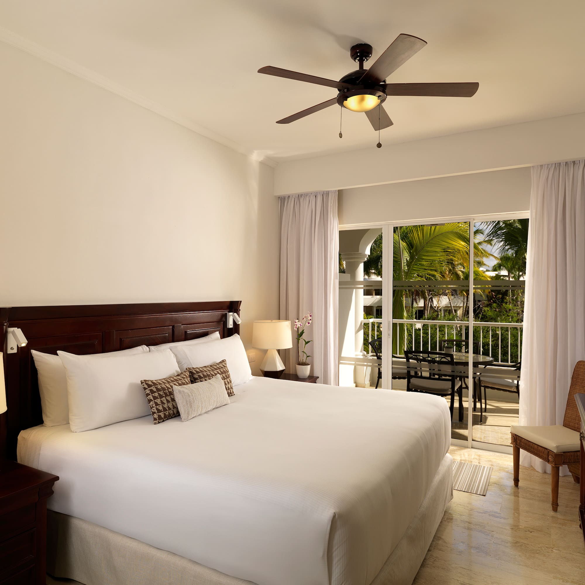 a bedroom with a ceiling fan and a bed