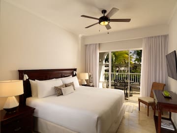 a bedroom with a ceiling fan and a bed