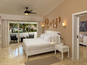 a bedroom with a bed and a ceiling fan