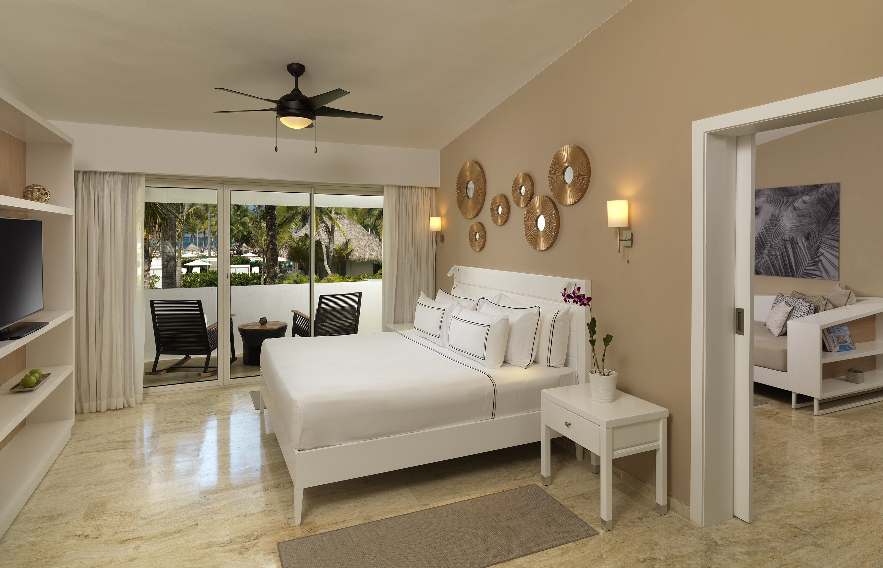 a bedroom with a bed and a ceiling fan
