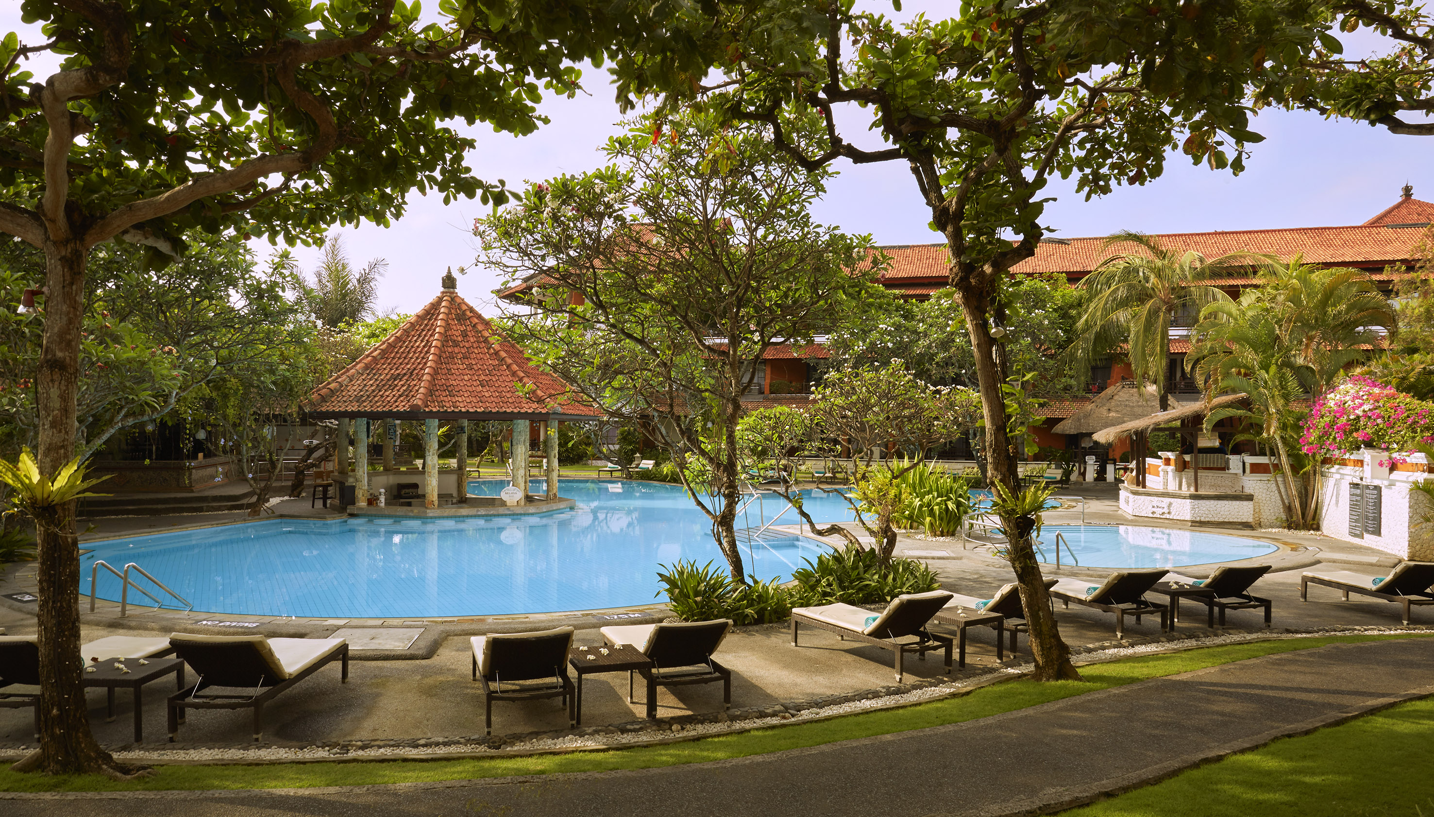 a pool with lounge chairs and a gazebo
