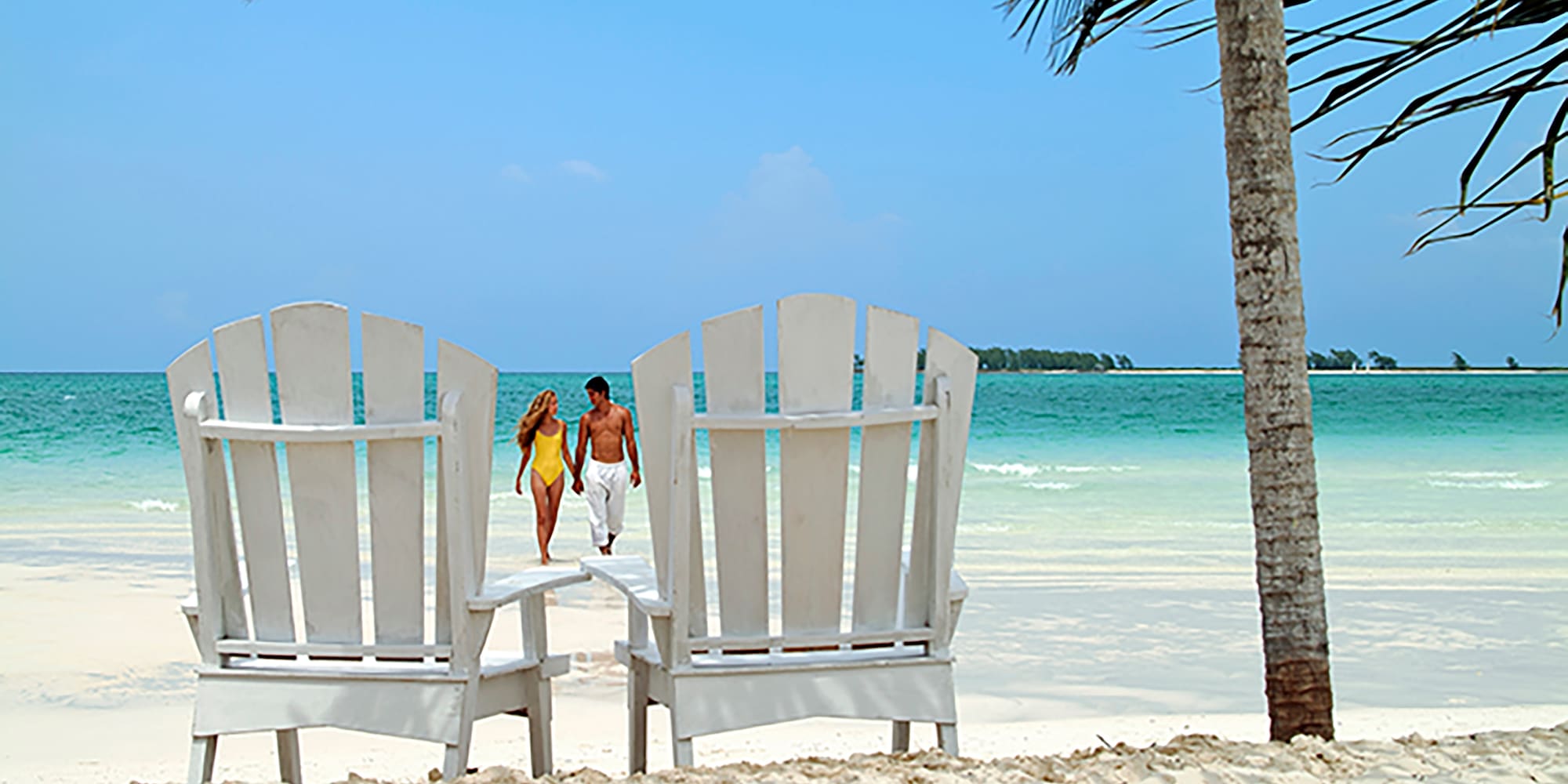 a couple walking on a beach