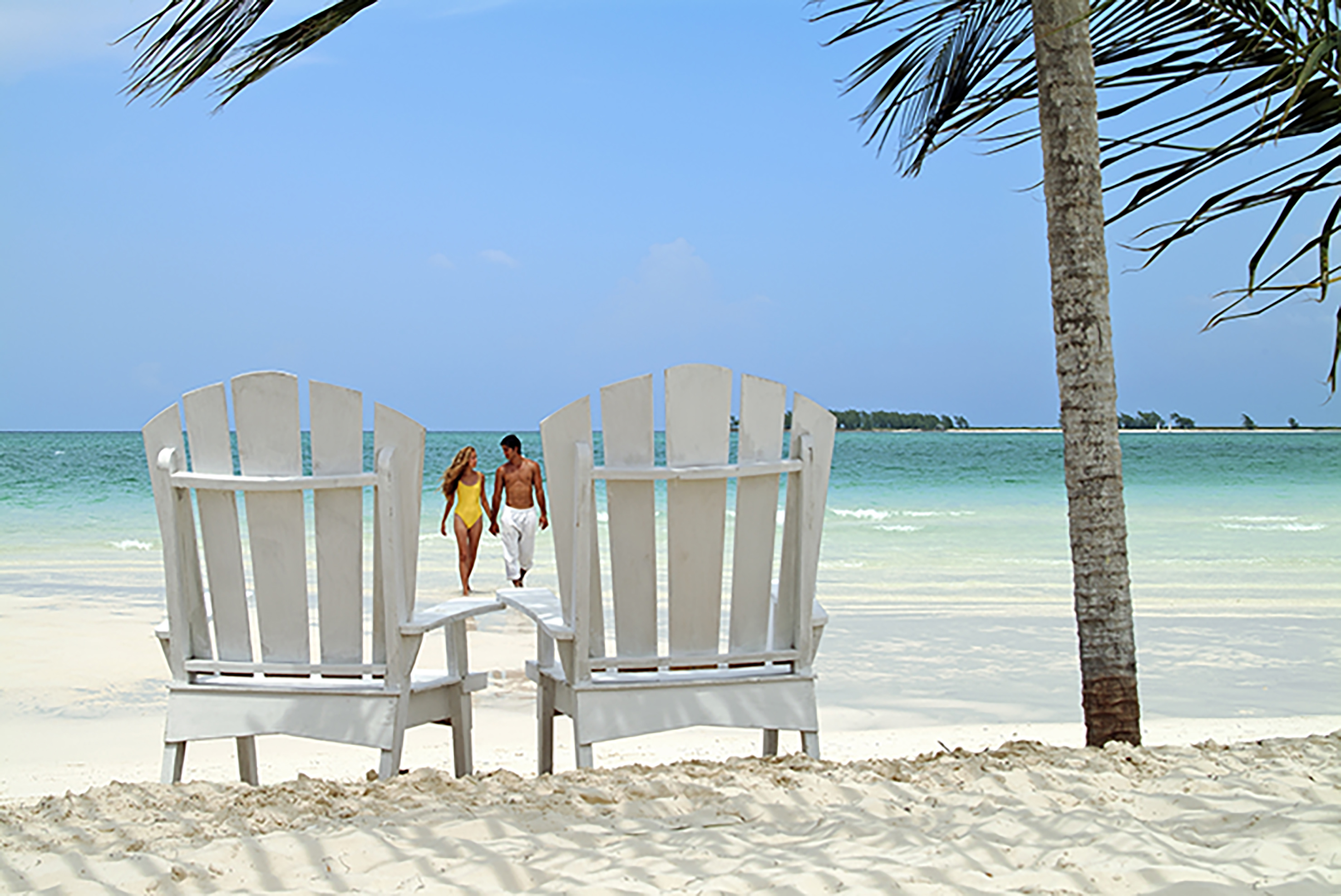 a couple walking on a beach