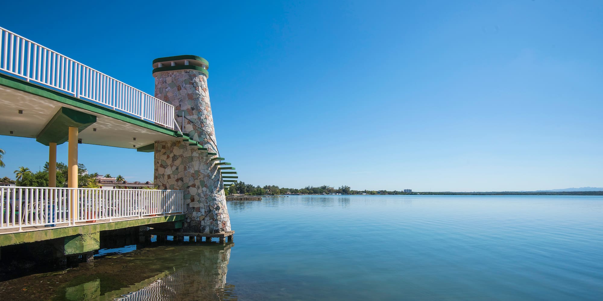 a building with a staircase on the water