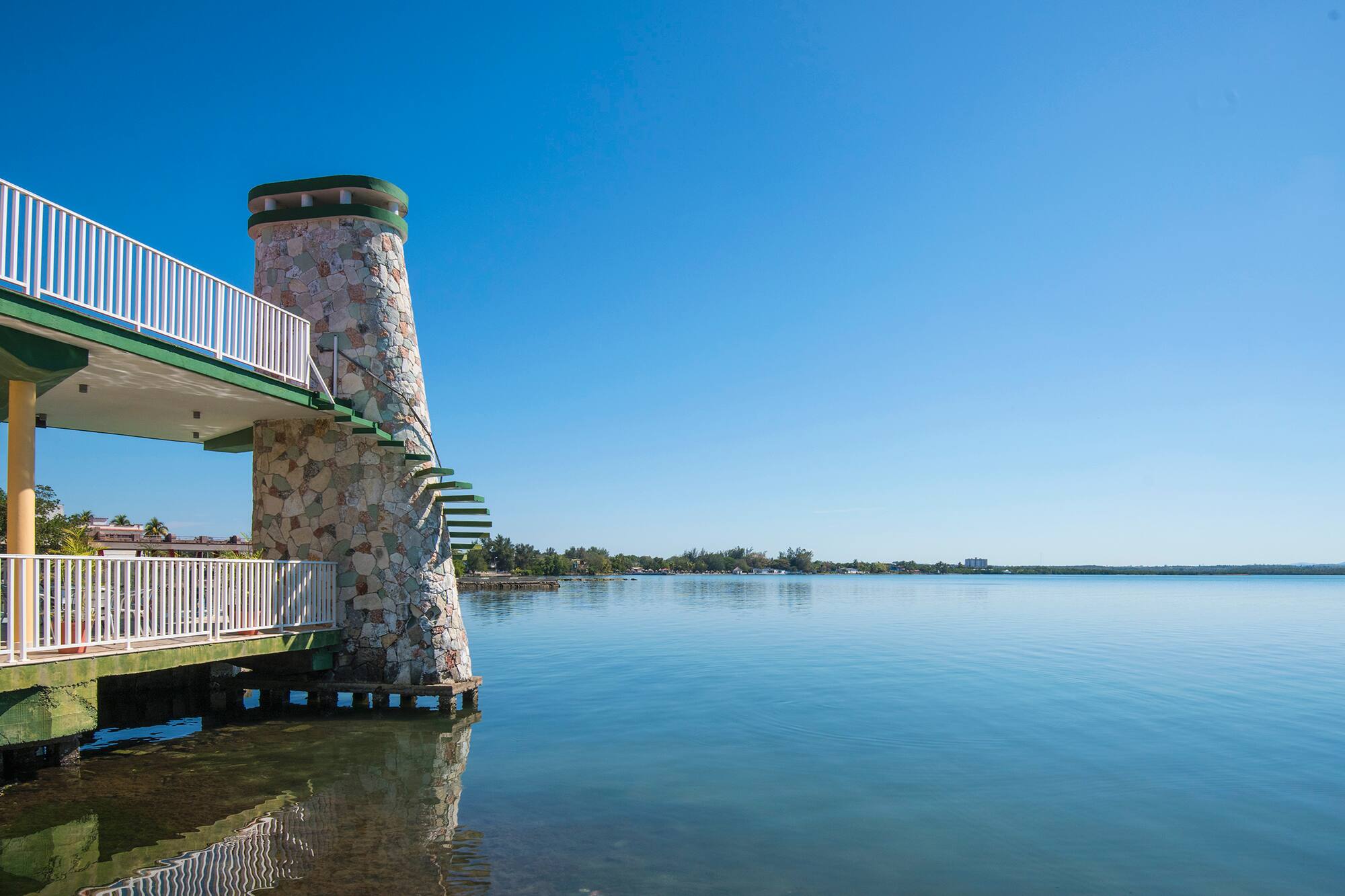 a building with a staircase on the water