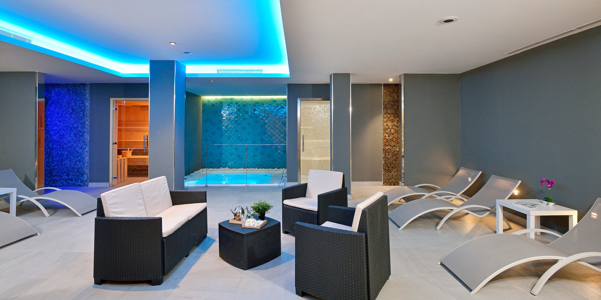 a room with chairs and a pool