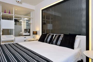 a bed with black and white striped pillows