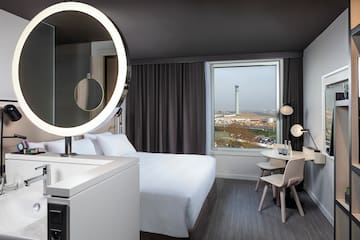 a room with a round mirror and a table