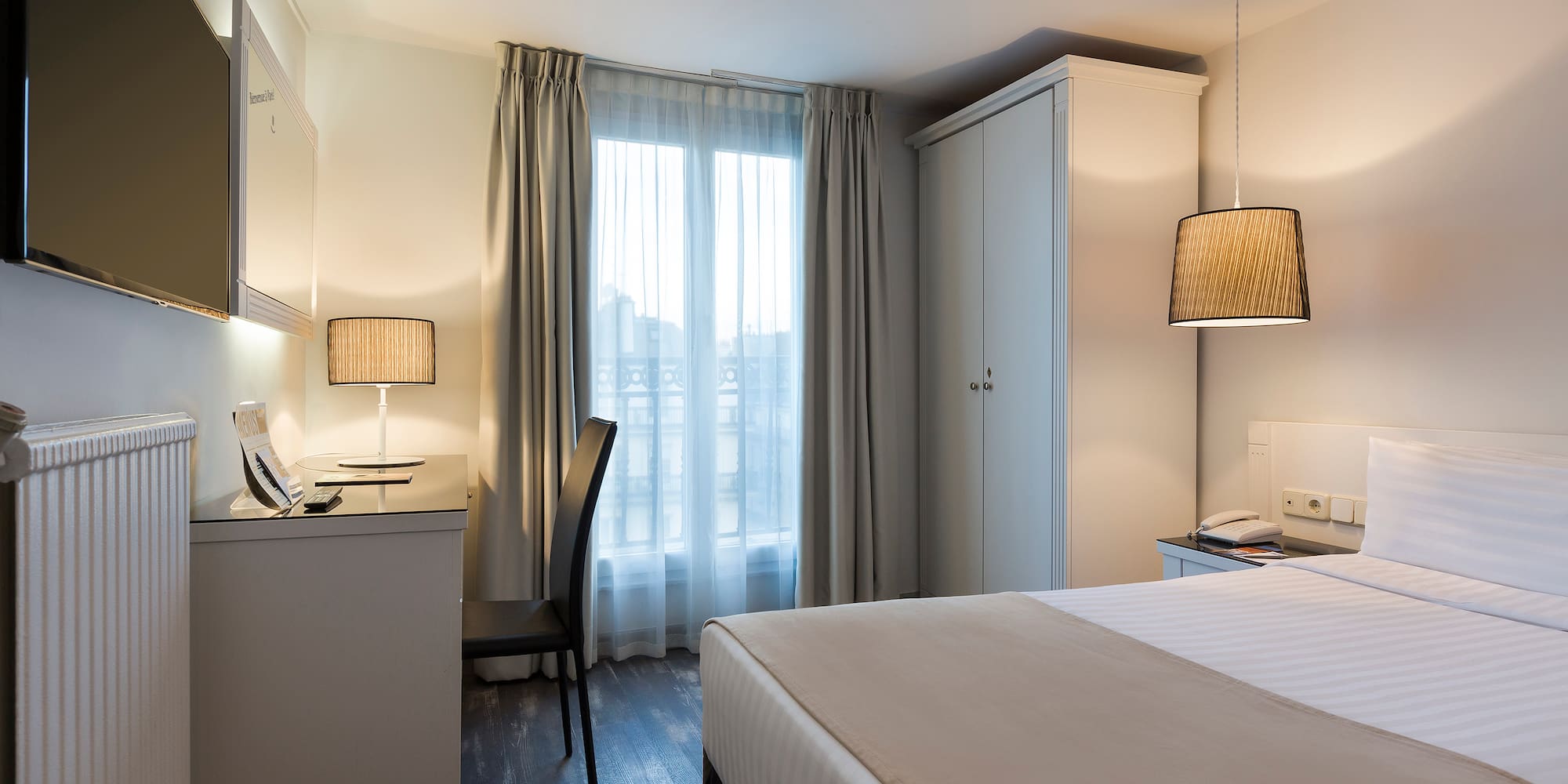 a bedroom with a bed and a desk