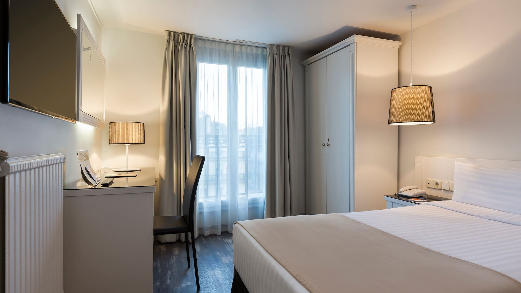 a bedroom with a bed and a desk