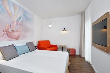 a room with two beds and a chair