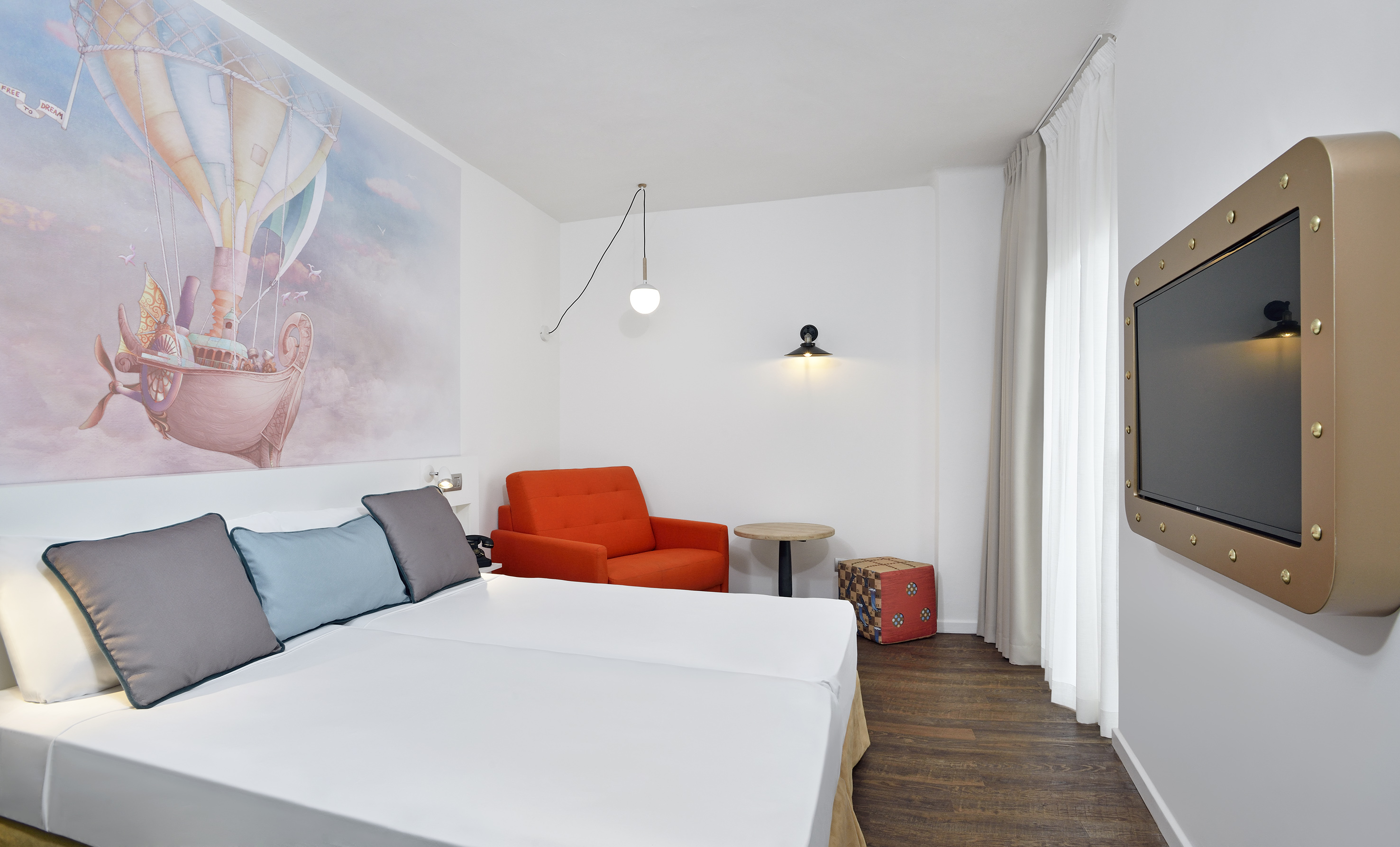 a room with two beds and a chair