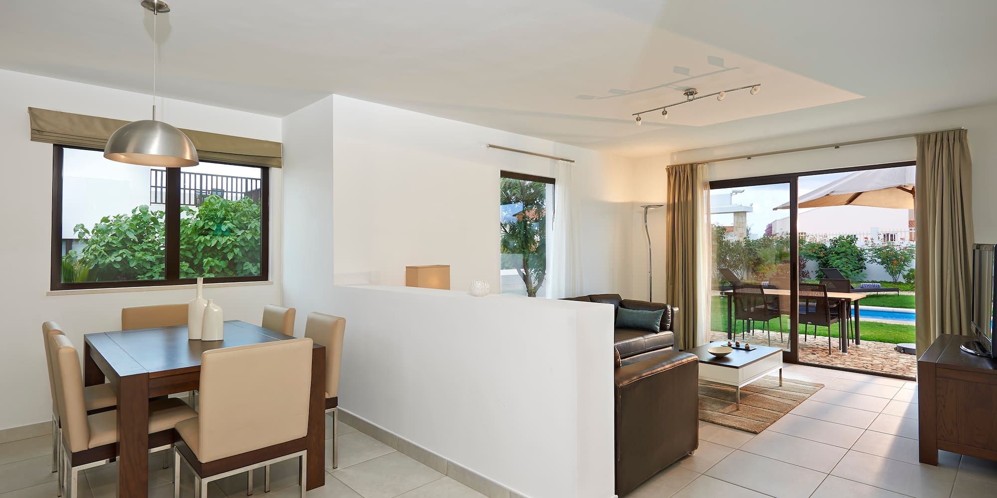 a room with a dining table and chairs