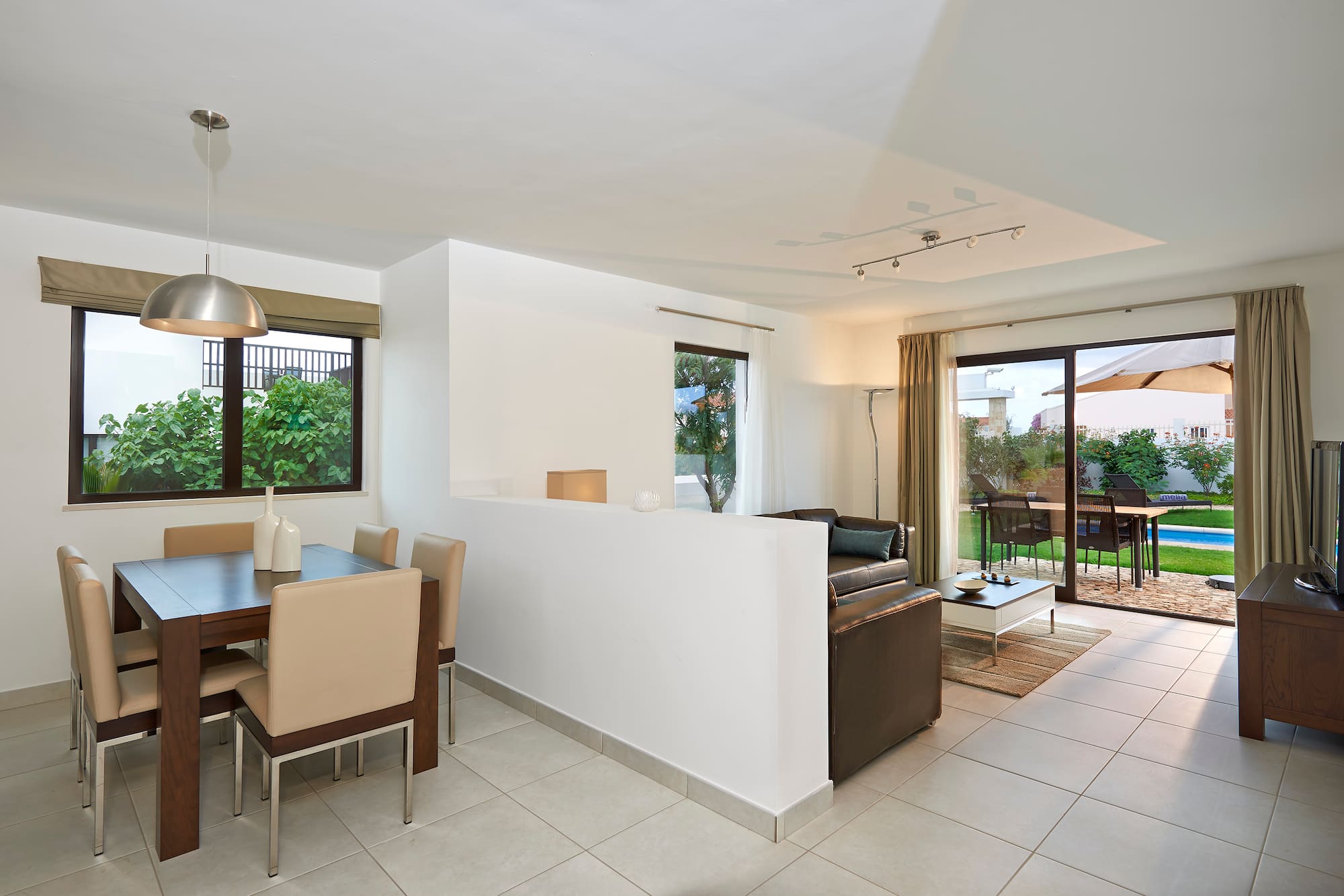 a room with a dining table and chairs