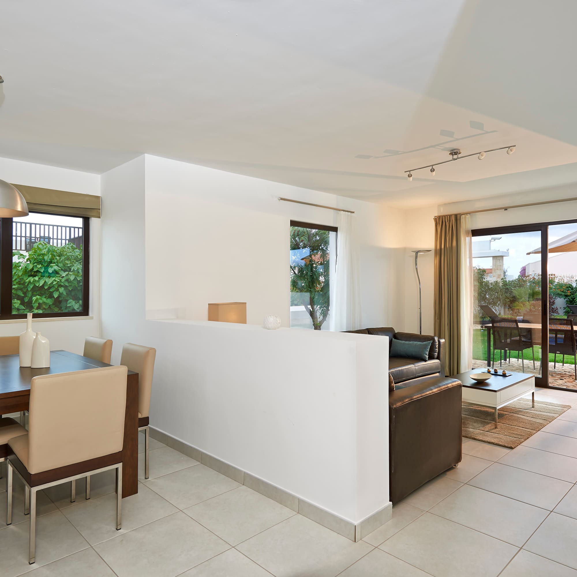 a room with a dining table and chairs