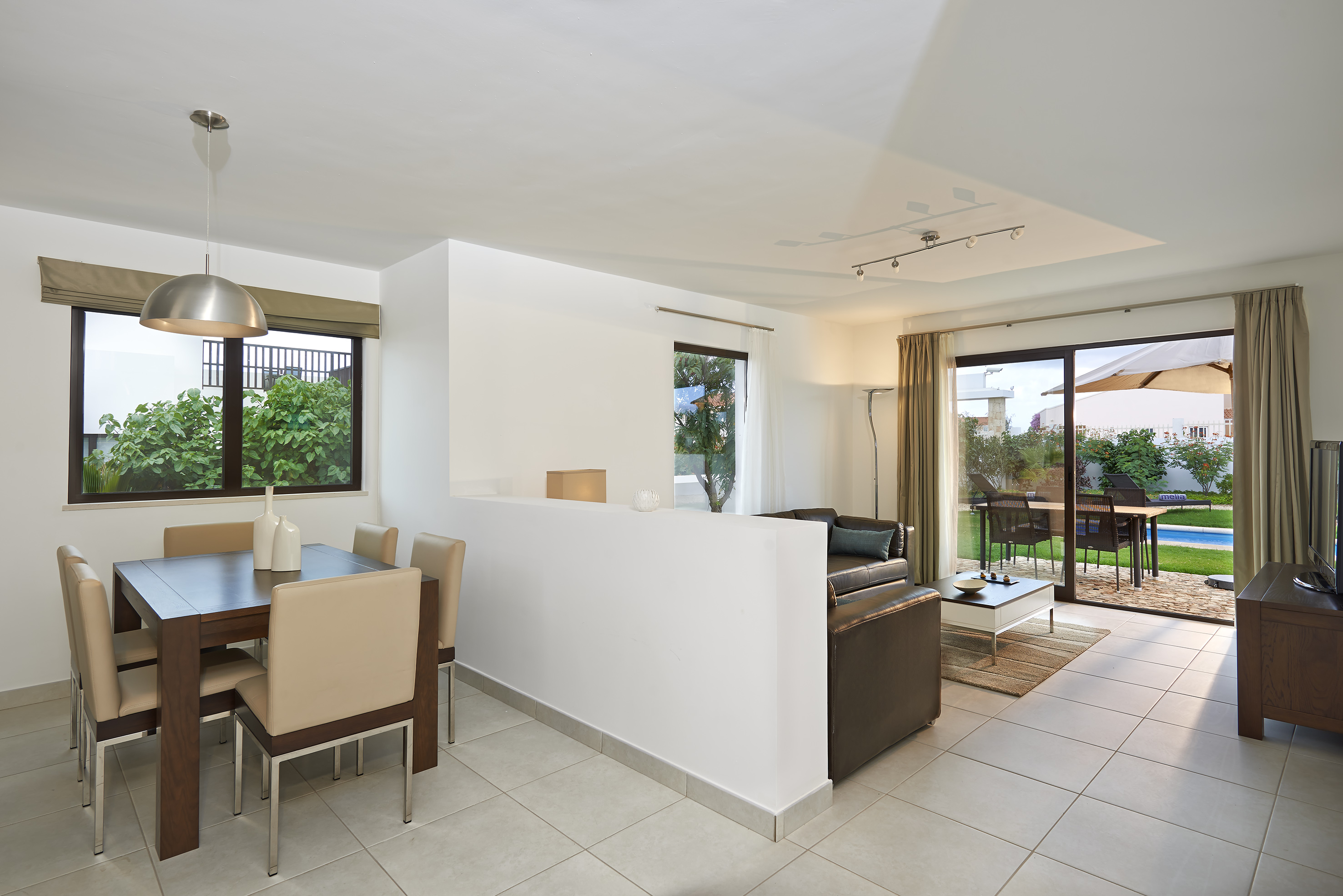 a room with a dining table and chairs