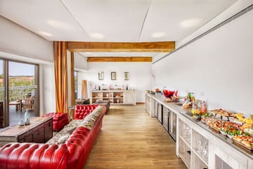 a room with a long couch and a buffet table
