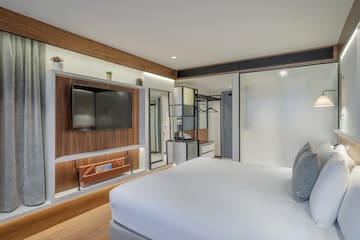 a room with a bed and a tv