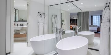 a bathroom with large tubs and mirrors