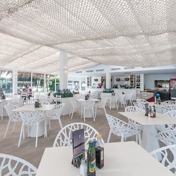 a white tables and chairs in a restaurant