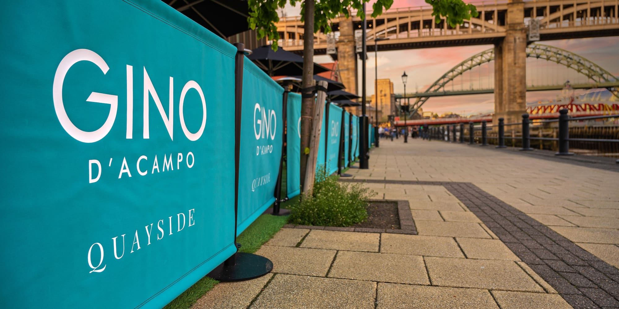a blue sign on a sidewalk