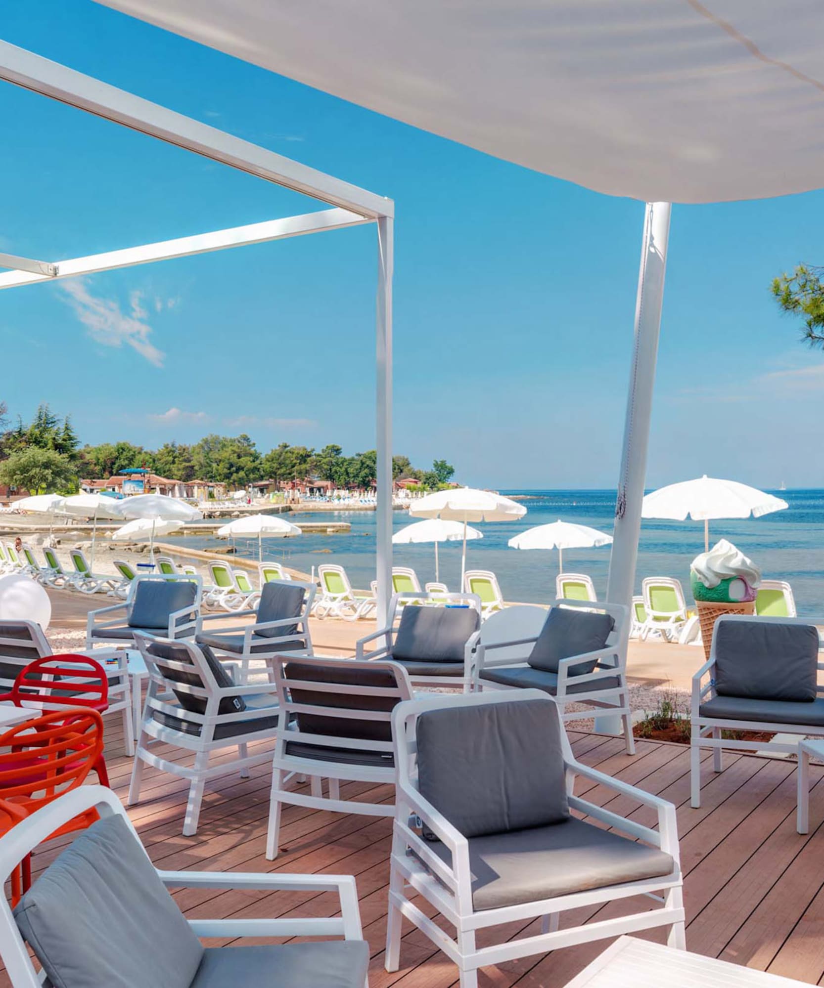 a beach with chairs and umbrellas