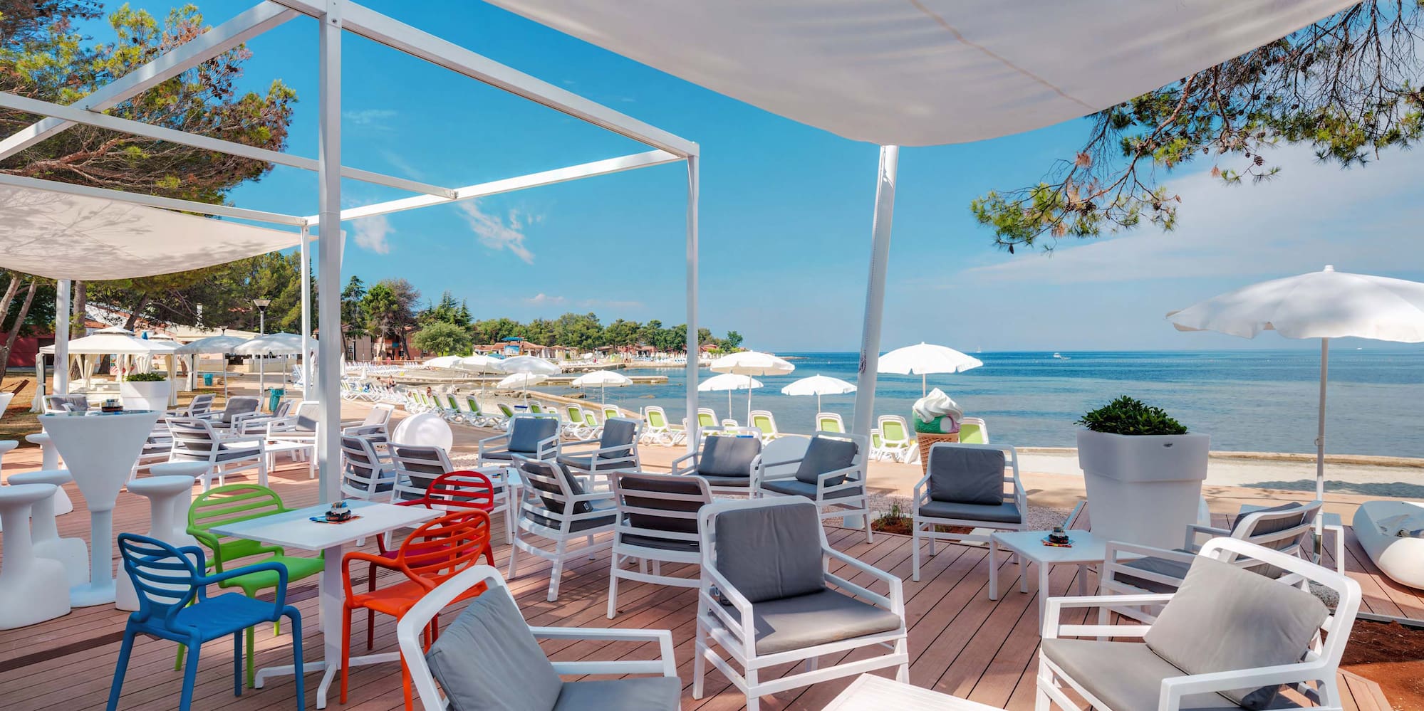 a beach with chairs and umbrellas