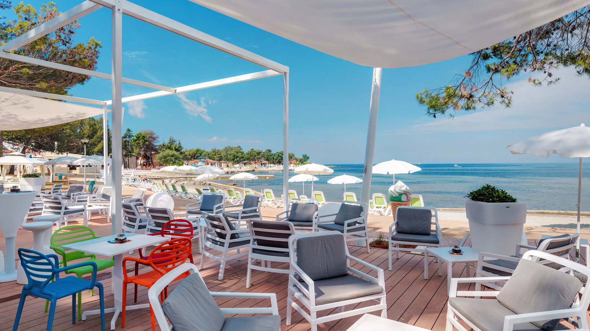 a beach with chairs and umbrellas
