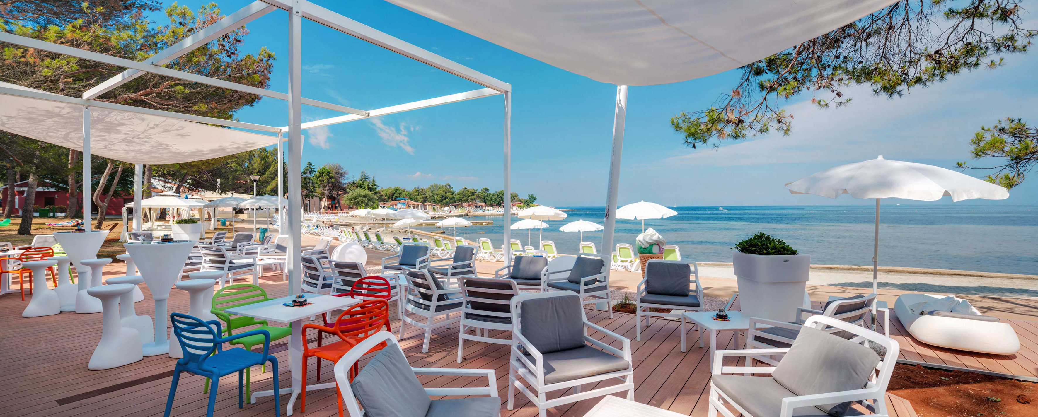 a beach with chairs and umbrellas