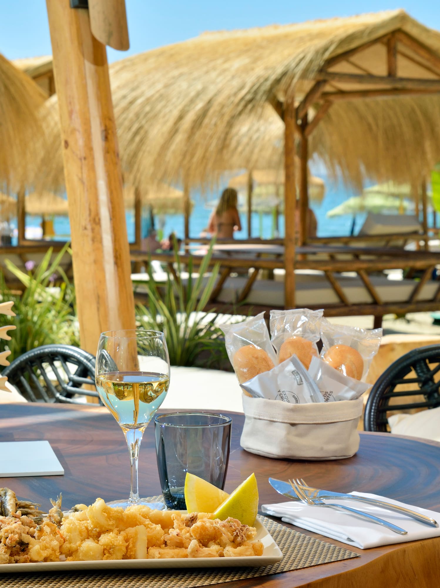 a table with food and a glass of wine on it