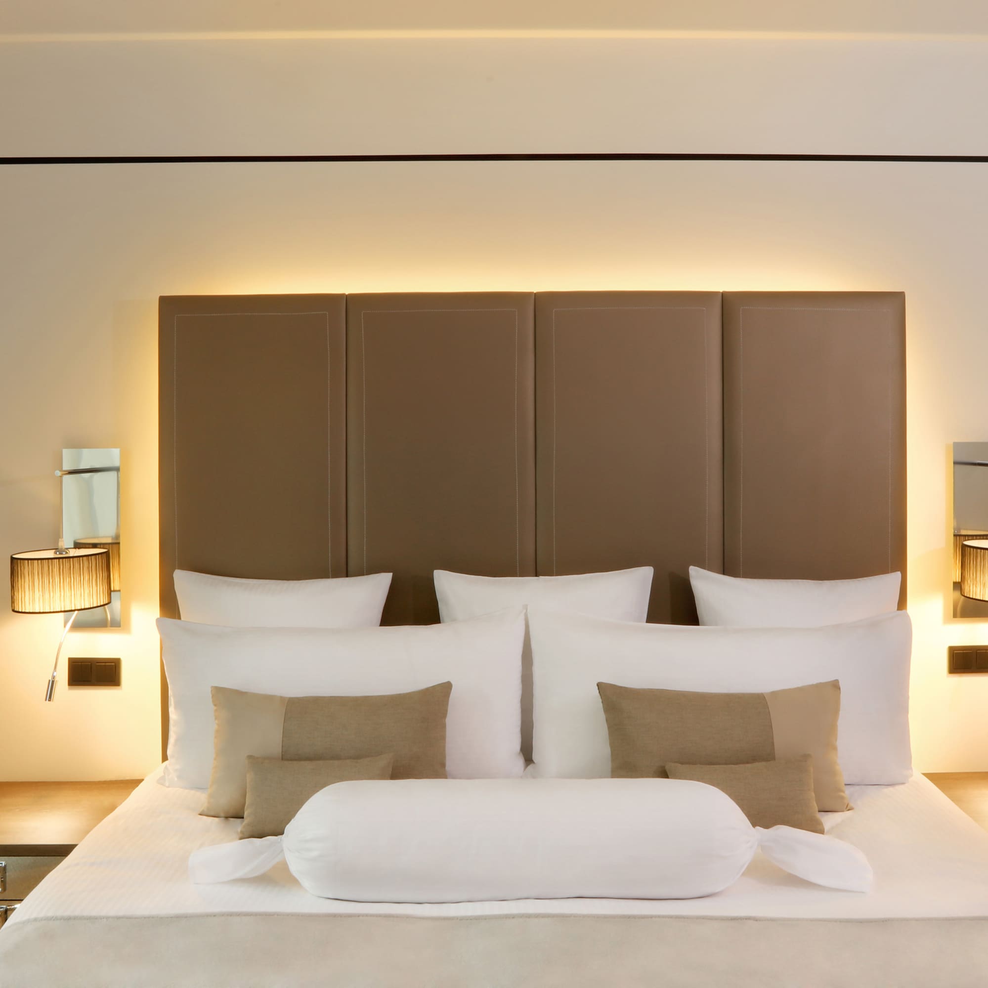 a bed with pillows and a headboard