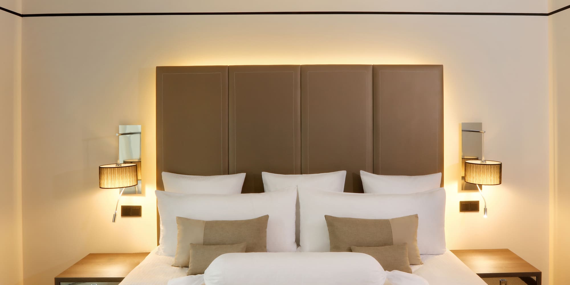 a bed with pillows and a headboard