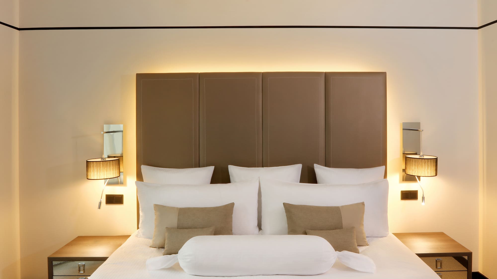 a bed with pillows and a headboard