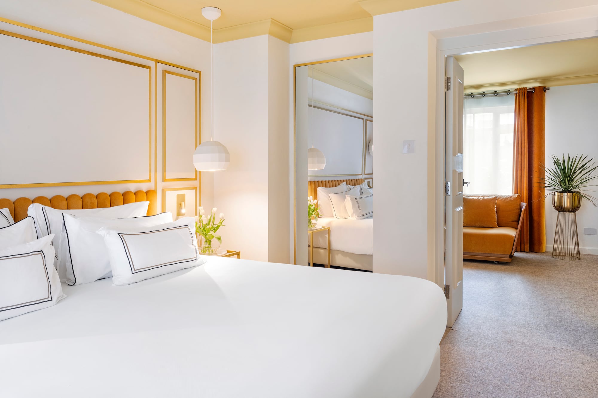 a bedroom with a bed and a mirror