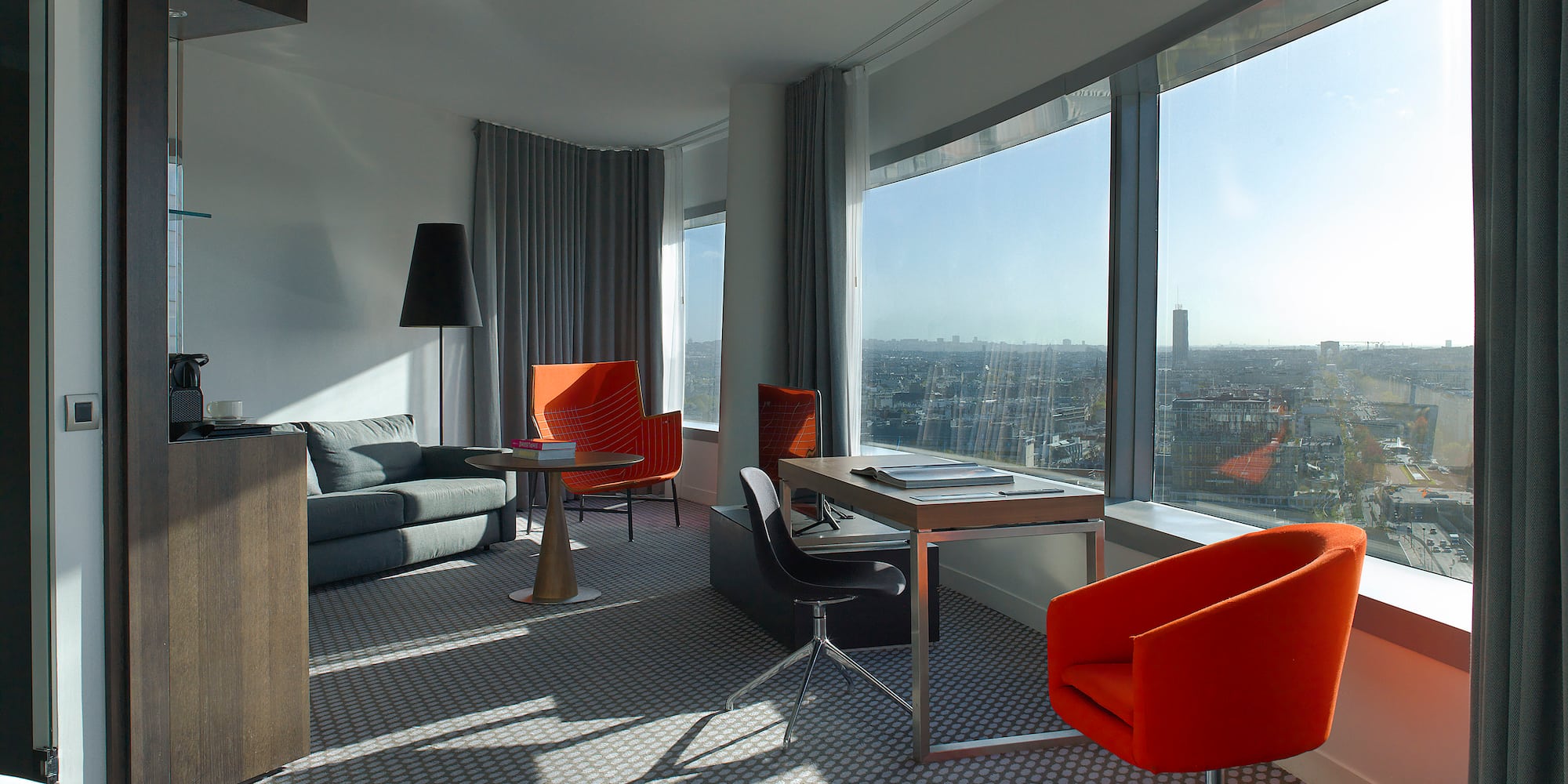 a room with a couch and chairs