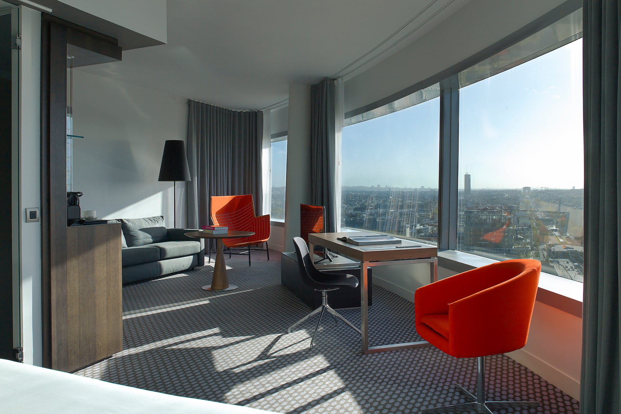 a room with a couch and chairs