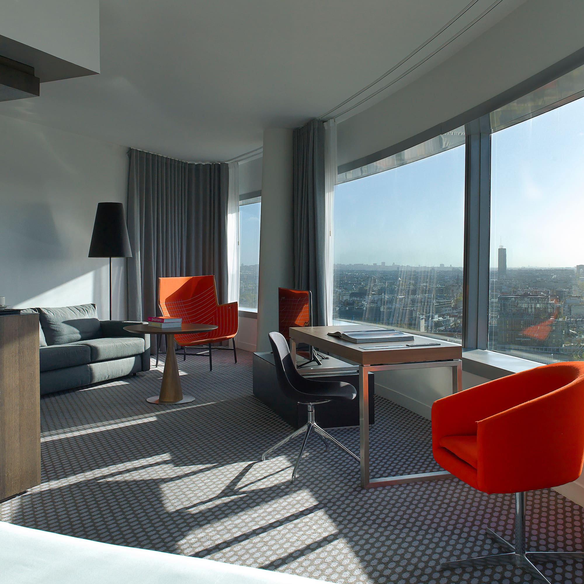 a room with a couch and chairs