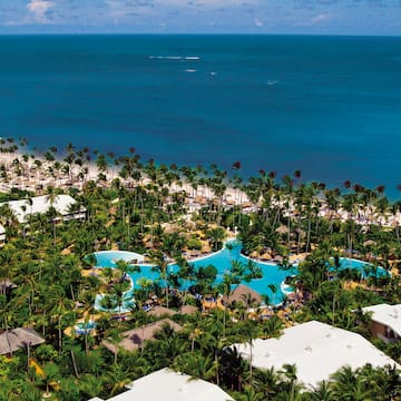 a aerial view of a resort with palm trees and a beach