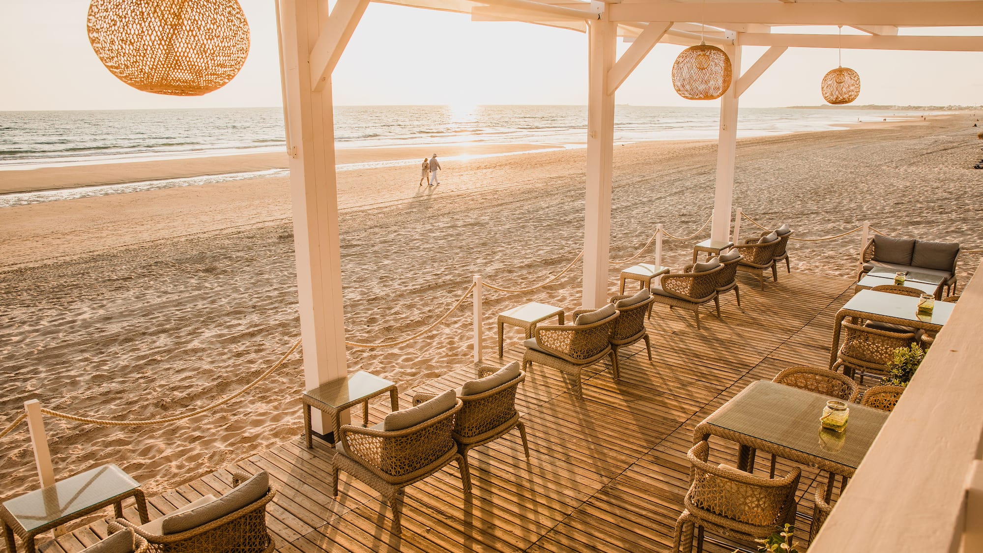 a beach with chairs and tables