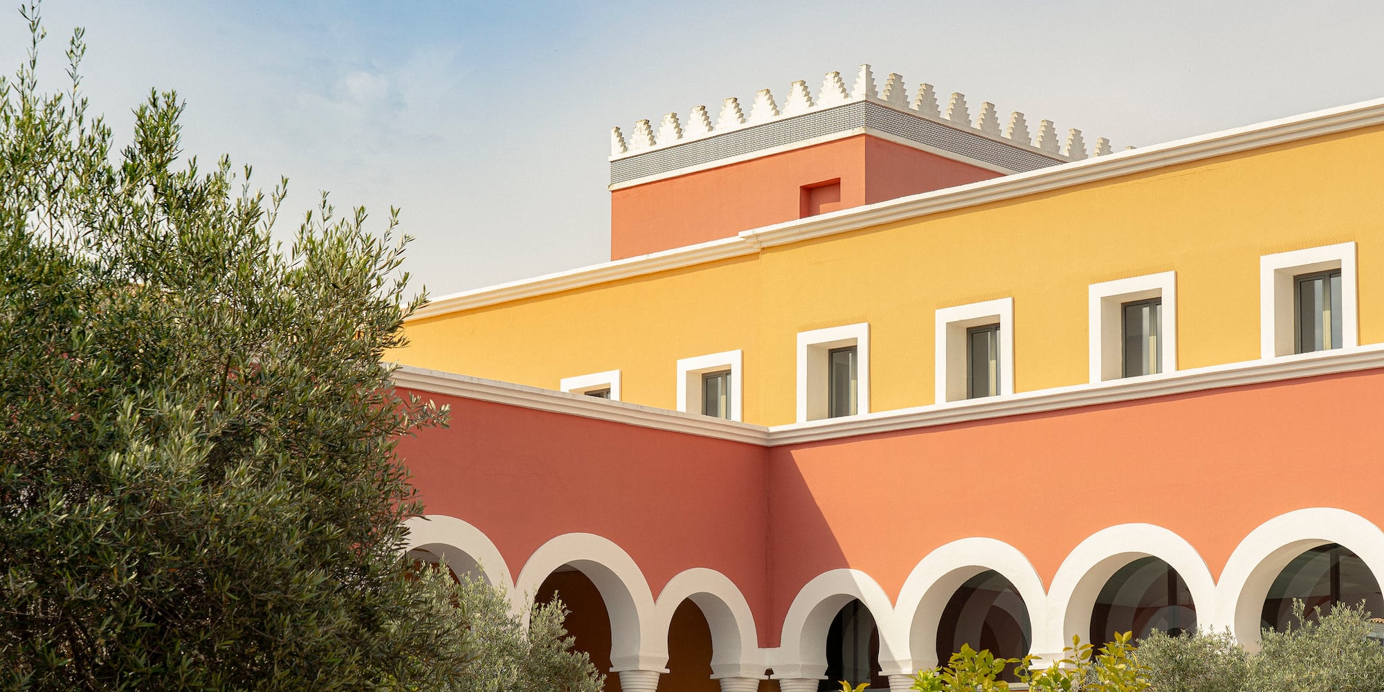 a building with many arches and trees