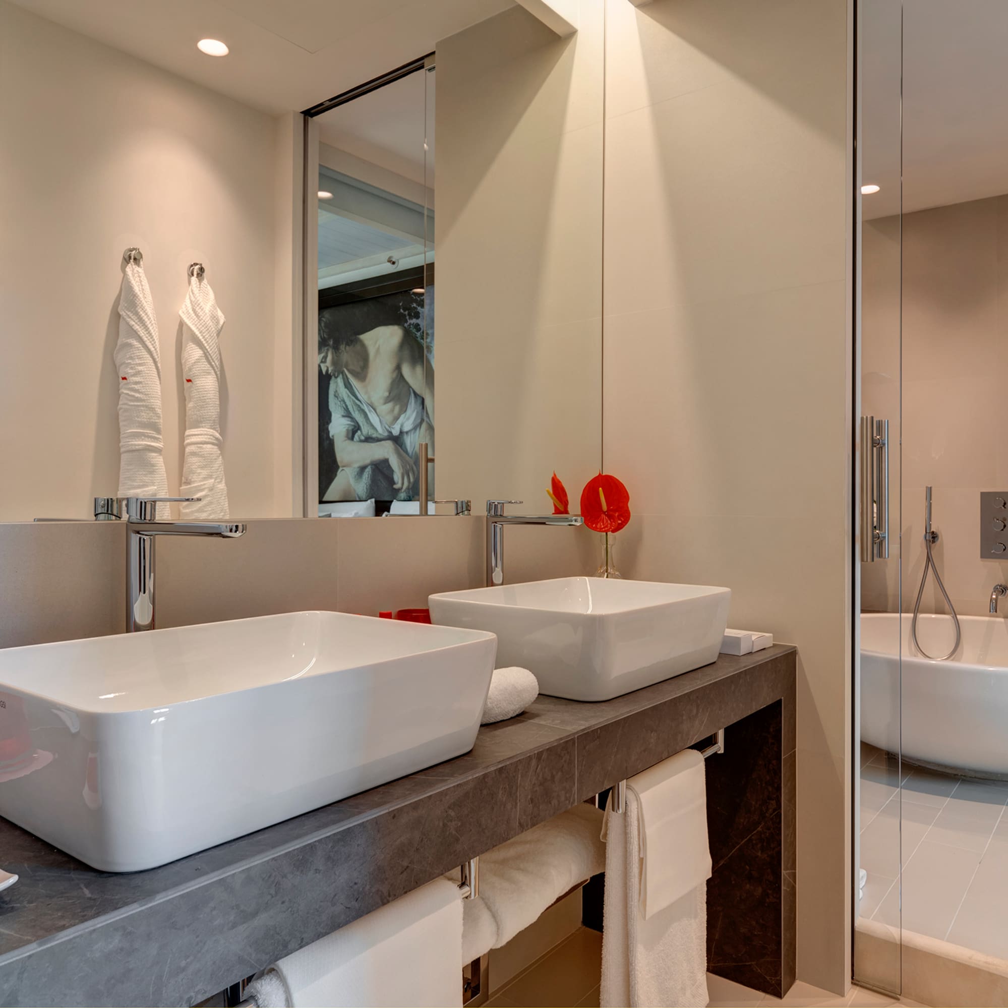 a bathroom with two sinks and a shower
